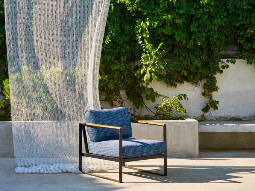 Fotografía de la silla frente a las cortinas ondulantes en la terraza al aire libre