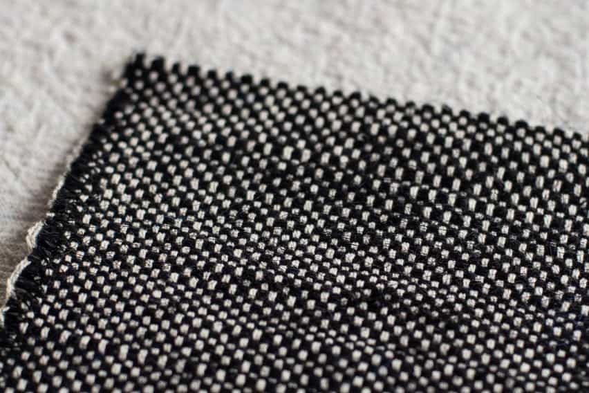 Foto de una pieza de tela tejida gruesa en blanco y negro tendida sobre una superficie